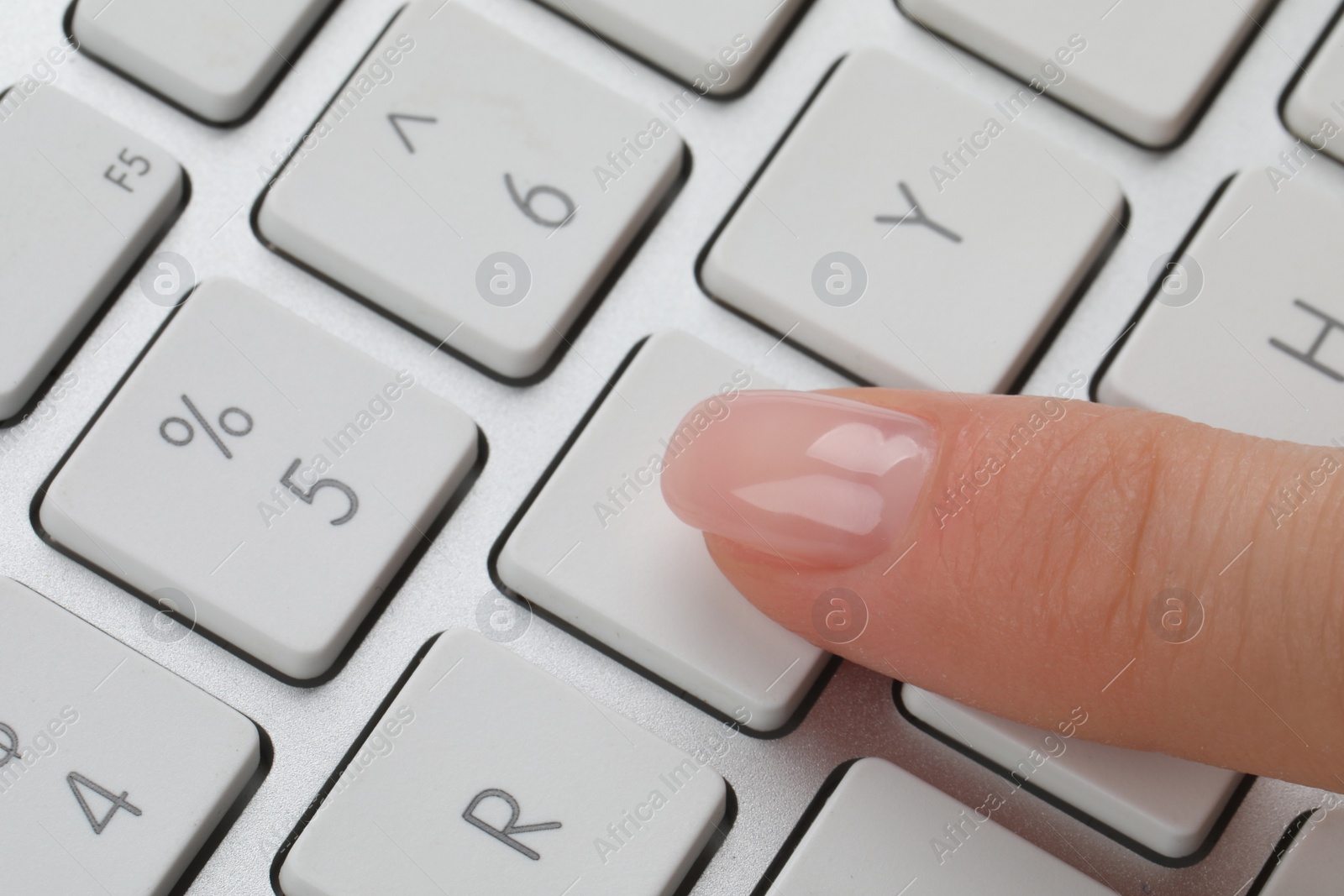 Photo of Woman pressing button on computer keyboard, closeup