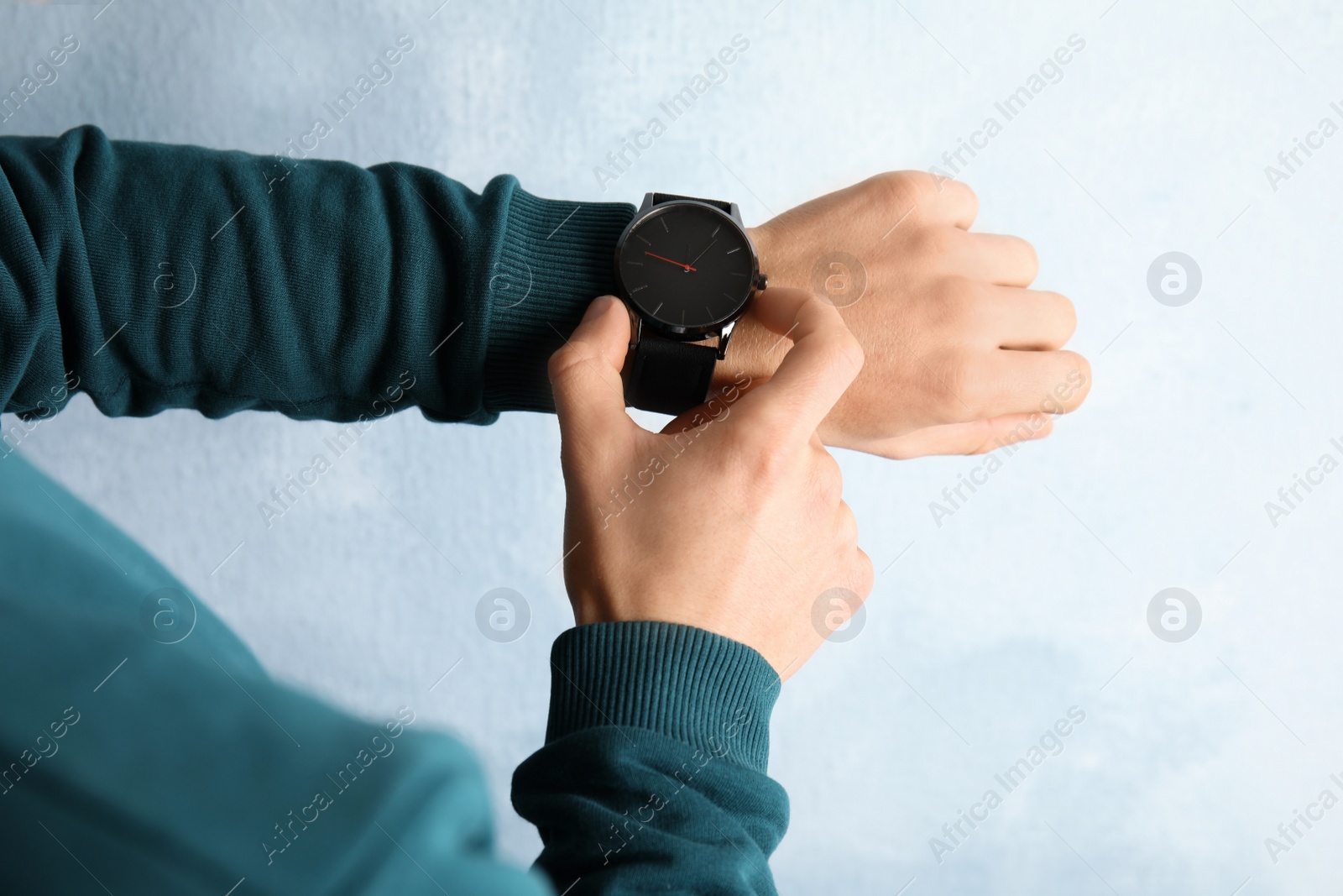 Photo of Man with stylish wrist watch on color background, closeup. Time management
