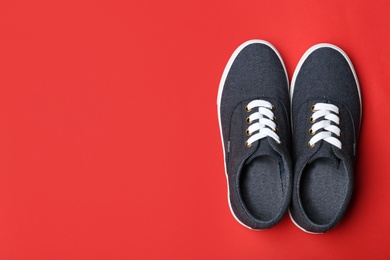 Photo of Stylish new shoes on color background, top view