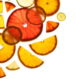 Photo of Illuminated slices of citrus fruits on white background, top view