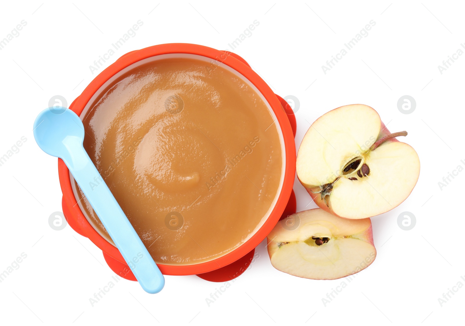 Photo of Tasty baby food in bowl, spoon and cut apple isolated on white, top view