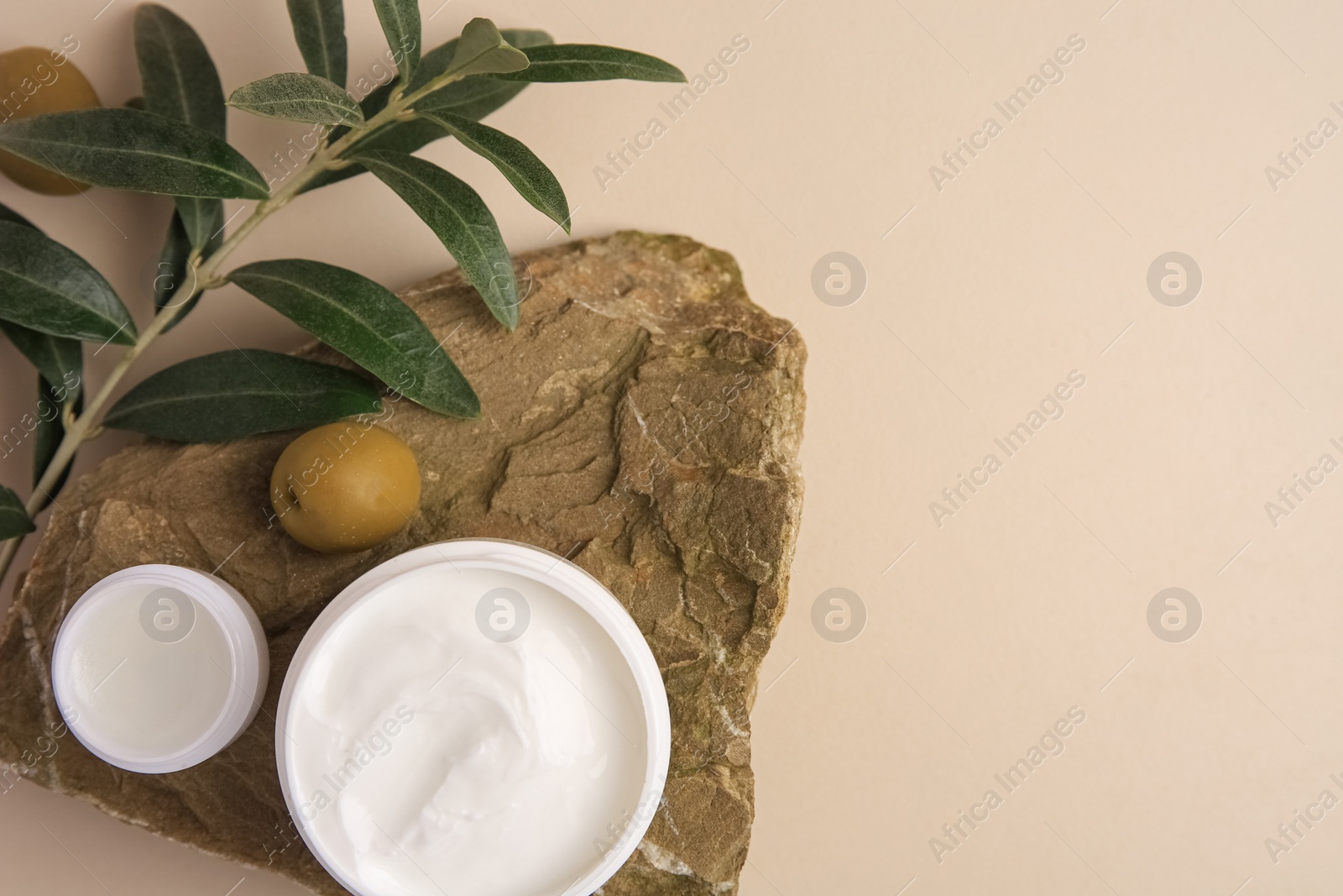 Photo of Flat lay composition with different natural cosmetic products on beige background. Space for text