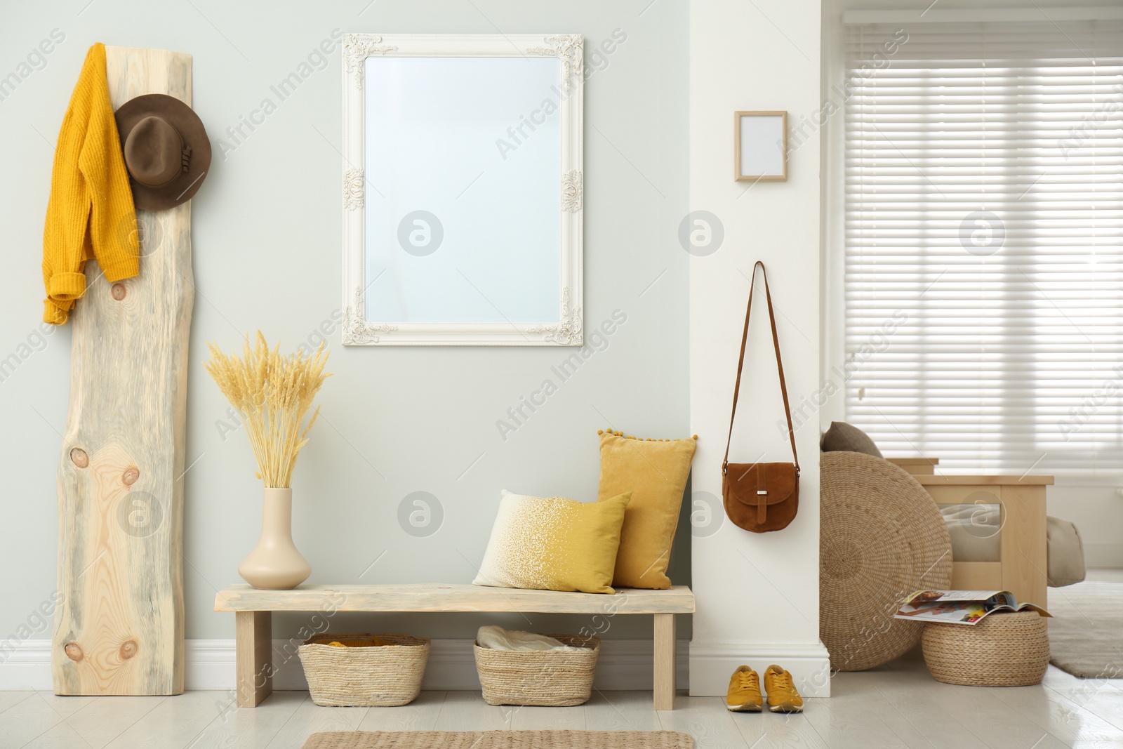 Photo of Hallway interior with wooden bench, clothes and mirror