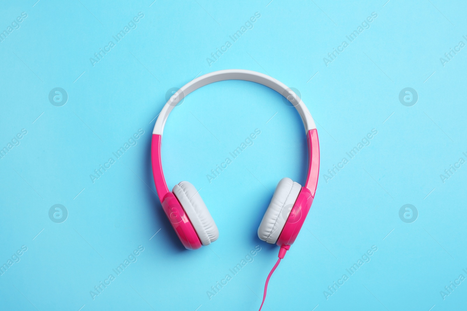 Photo of Stylish headphones on color background, top view