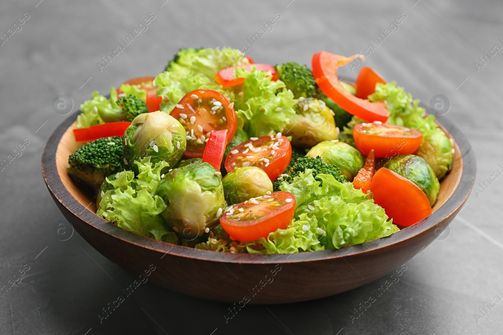 Photo of Tasty salad with Brussels sprouts on grey table