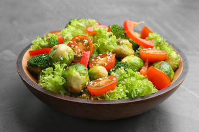 Photo of Tasty salad with Brussels sprouts on grey table