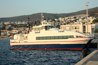 Photo of Modern ferry moored in sea port on summer day