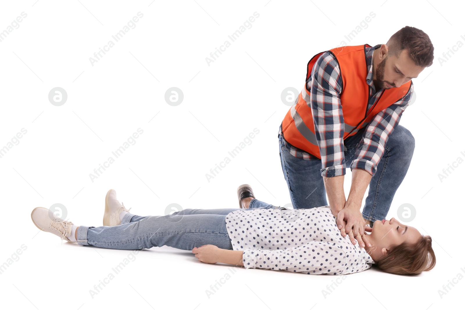 Photo of Paramedic in uniform performing first aid on unconscious woman against white background