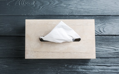 Box of tissues on grey wooden table, top view