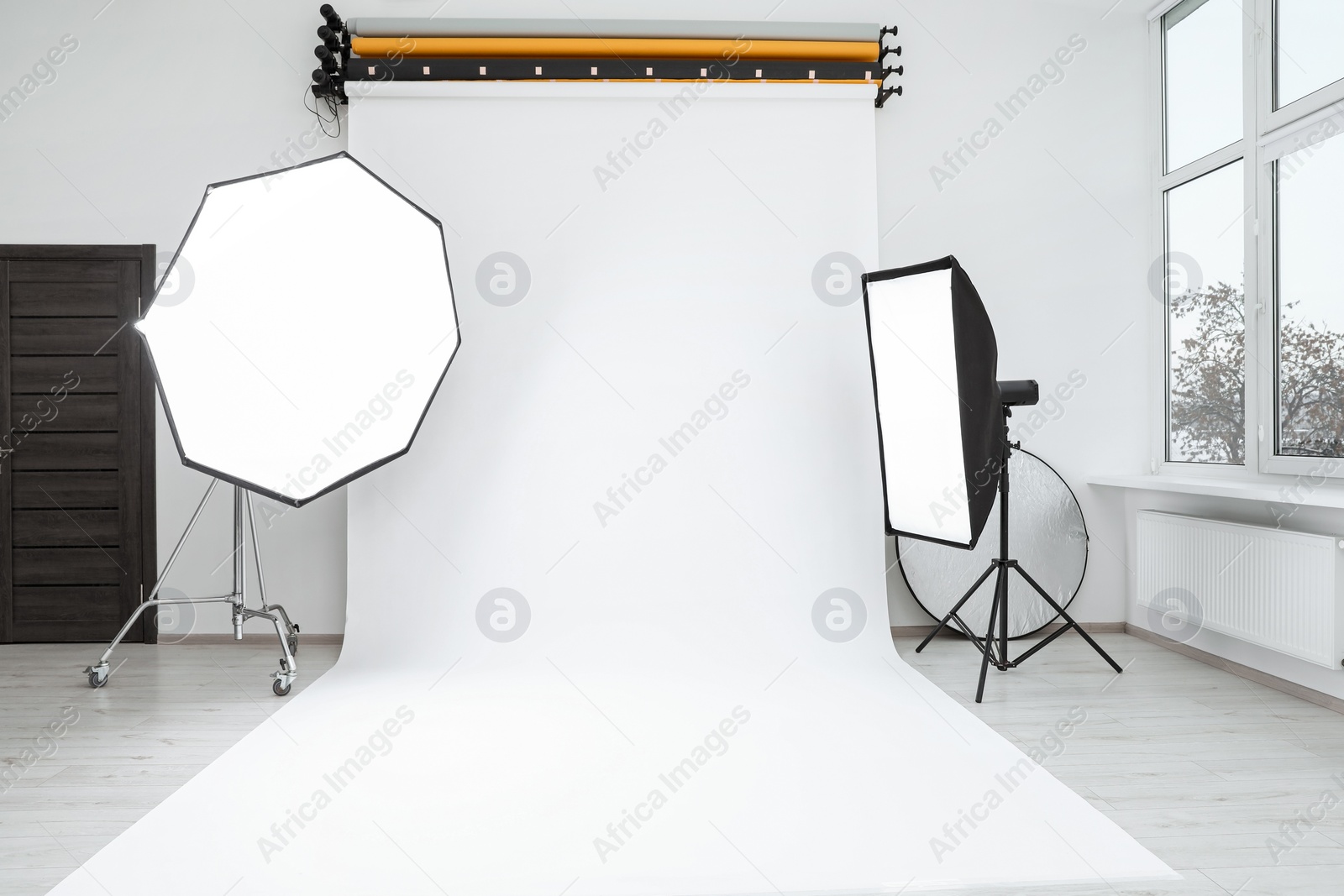 Photo of Interior of modern photo studio with professional lighting equipment