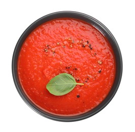 Photo of Delicious tomato cream soup in bowl isolated on white, top view