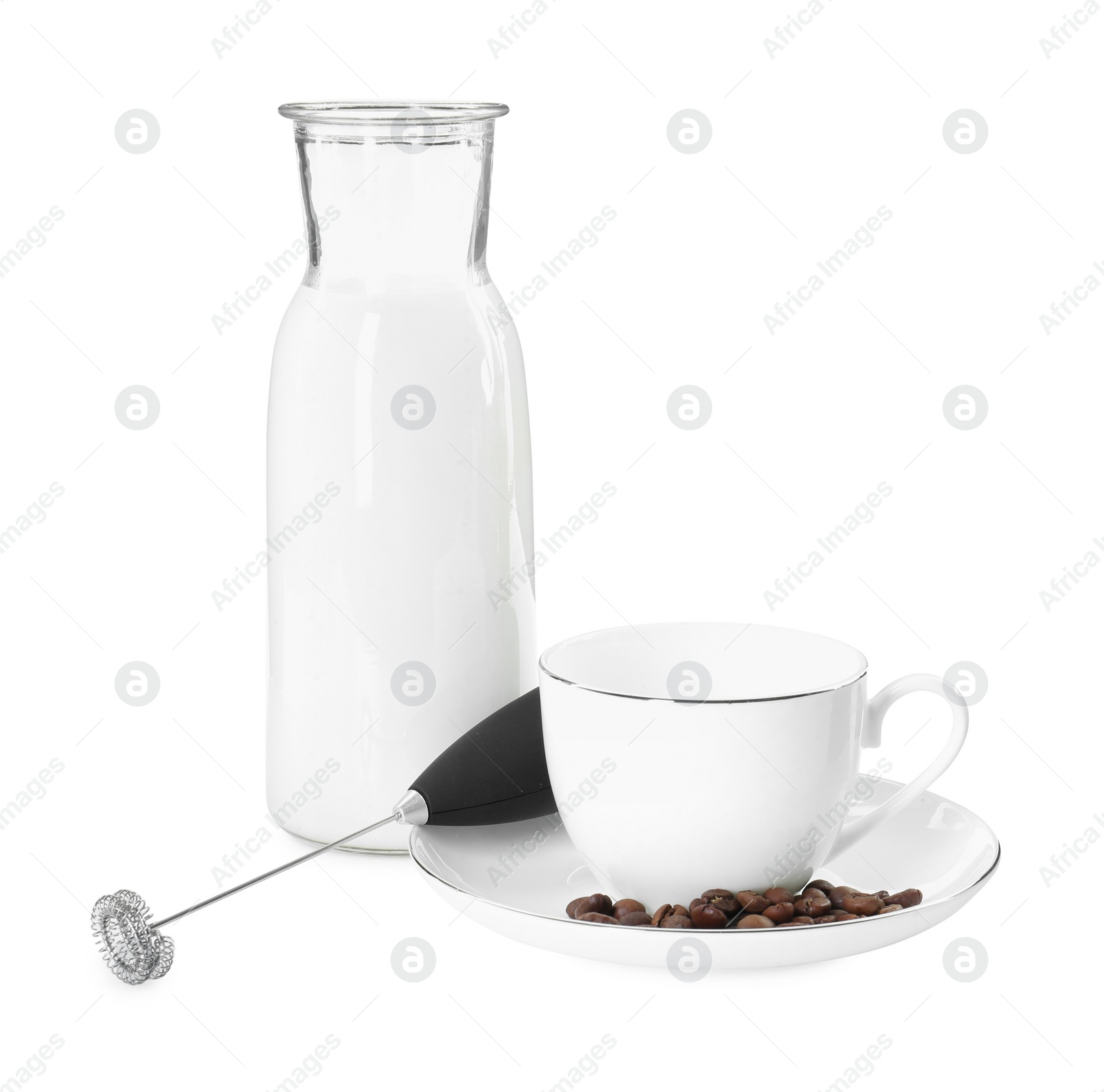 Photo of Mini mixer (milk frother), cup, coffee beans and bottle isolated on white