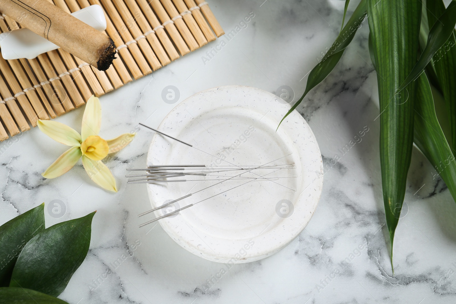 Photo of Flat lay composition with acupuncture needles on white marble table