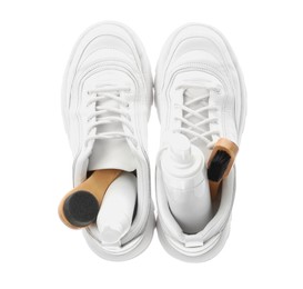 Photo of Stylish footwear with shoe care accessories on white background, top view