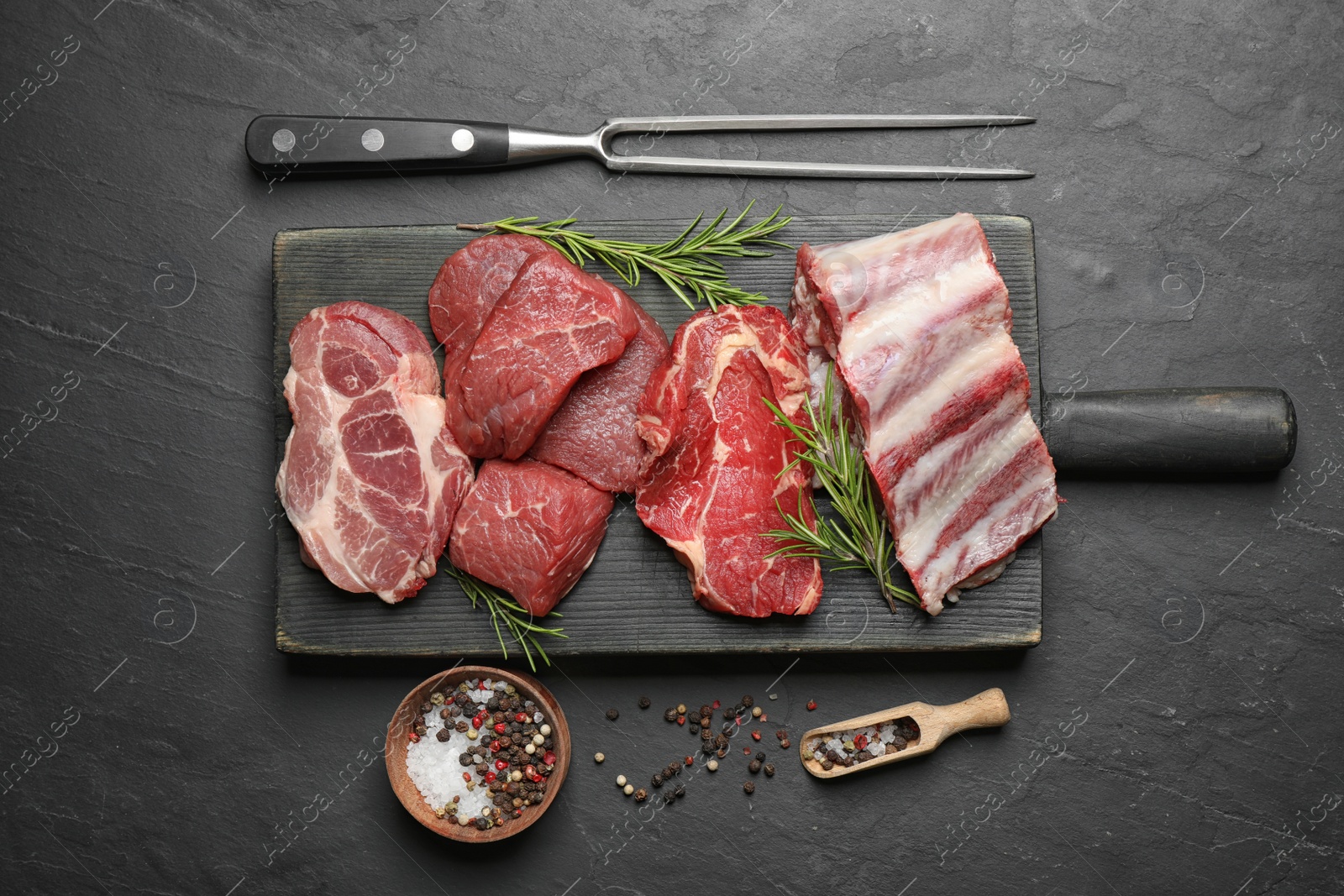 Photo of Flat lay composition with fresh meat on black table