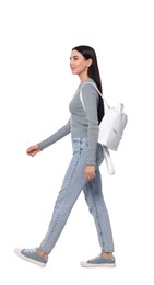 Woman with leather bag walking on white background
