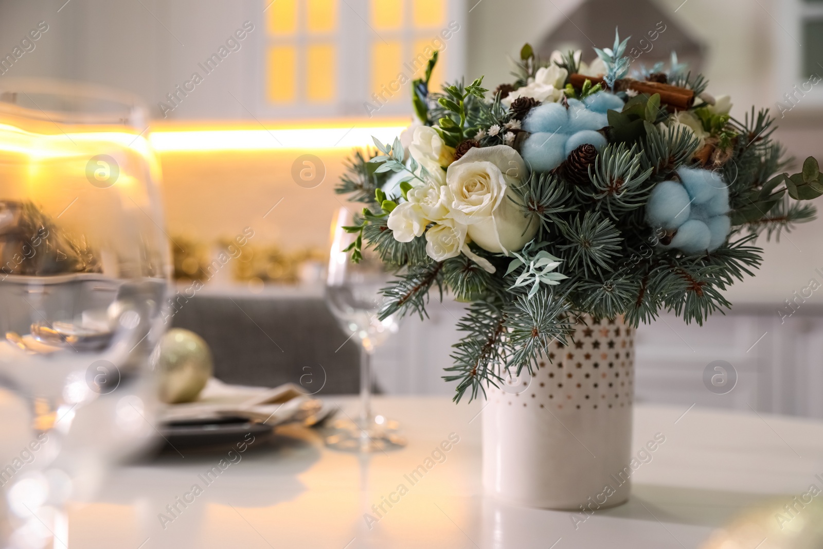 Photo of Beautiful winter bouquet on white table in kitchen