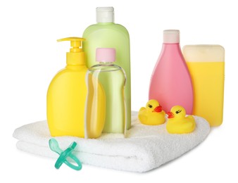 Bottles of baby cosmetic products, towel, pacifier and rubber ducks on white background