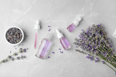 Photo of Flat lay composition with natural lavender essential oil on marble table