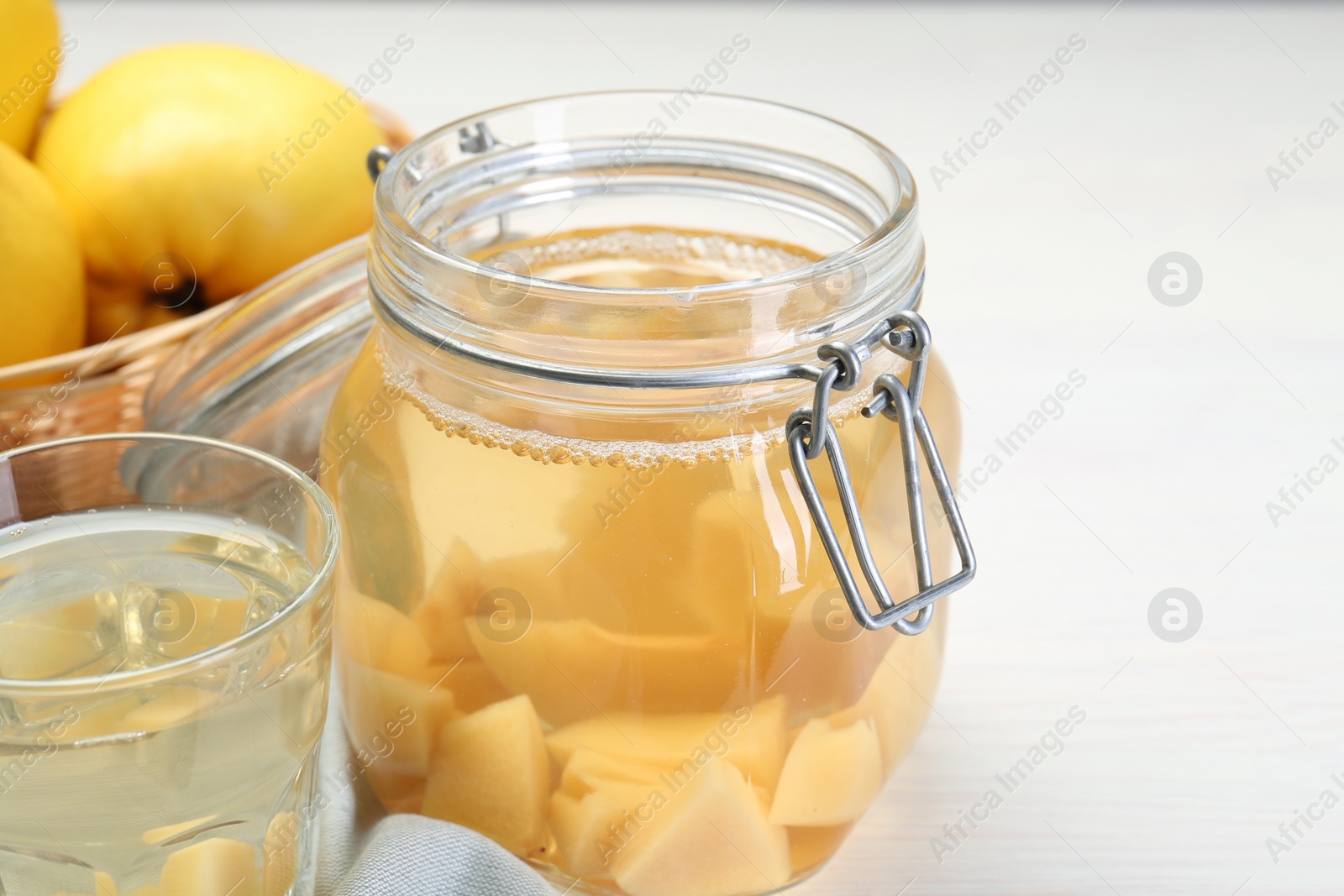 Photo of Delicious quince drink on white table, closeup