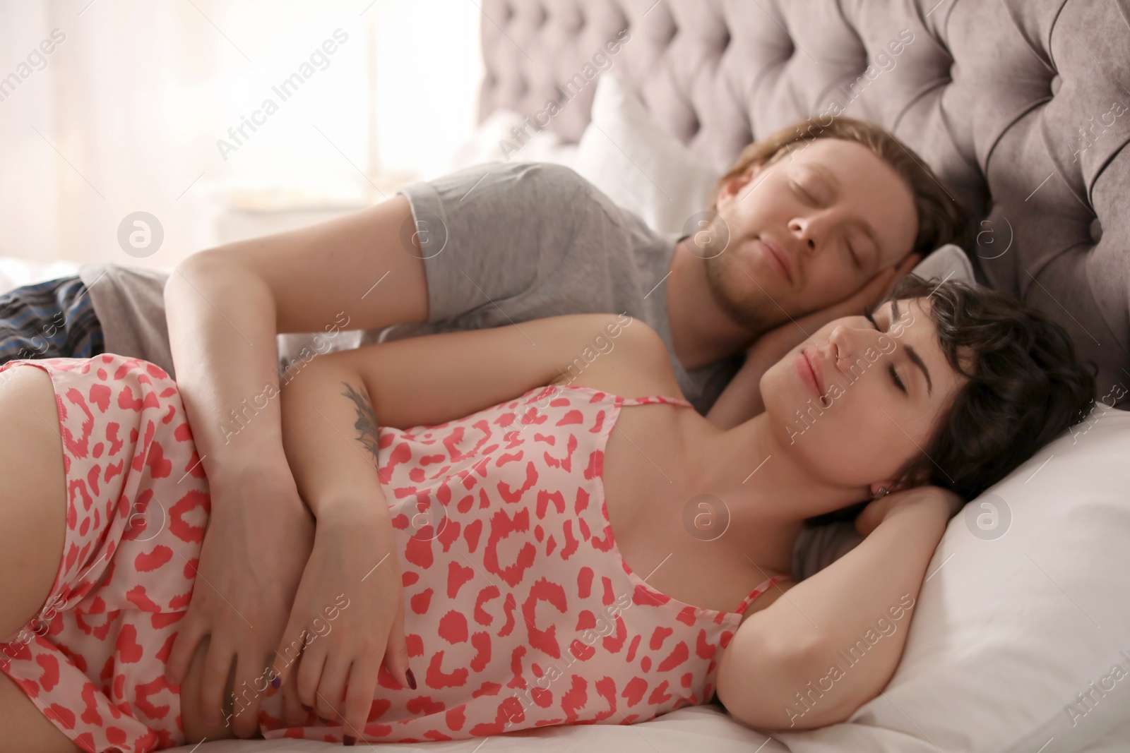 Photo of Young lovely couple sleeping in bed at home