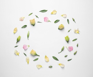 Flat lay composition with beautiful Eustoma flowers on light background, space for text