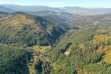 Beautiful mountains covered with forest on sunny day. Drone photography