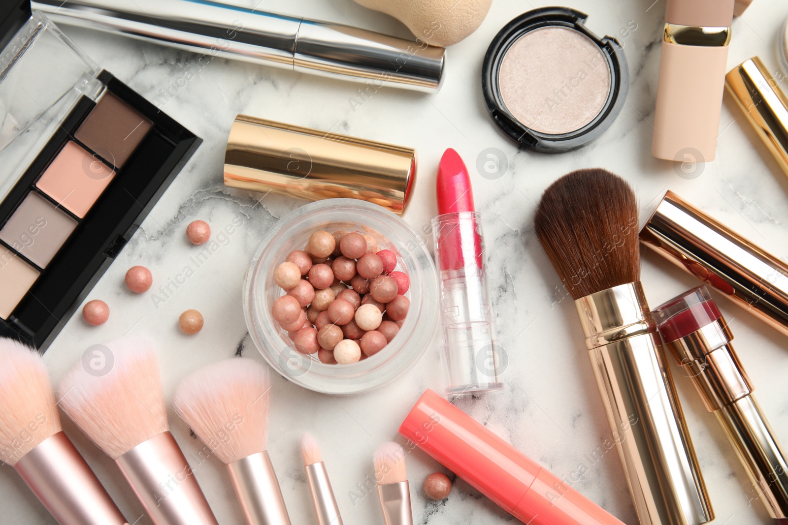 Photo of Flat lay composition with makeup products on white marble table