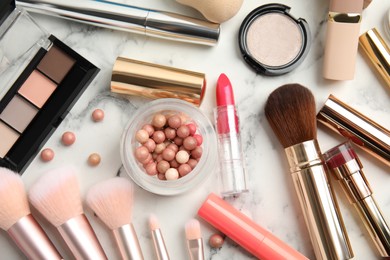 Flat lay composition with makeup products on white marble table