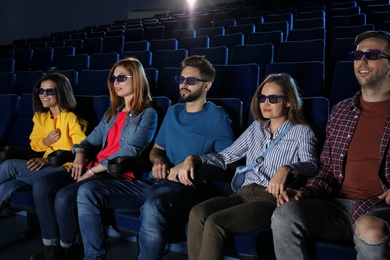 Young people watching movie in cinema theatre