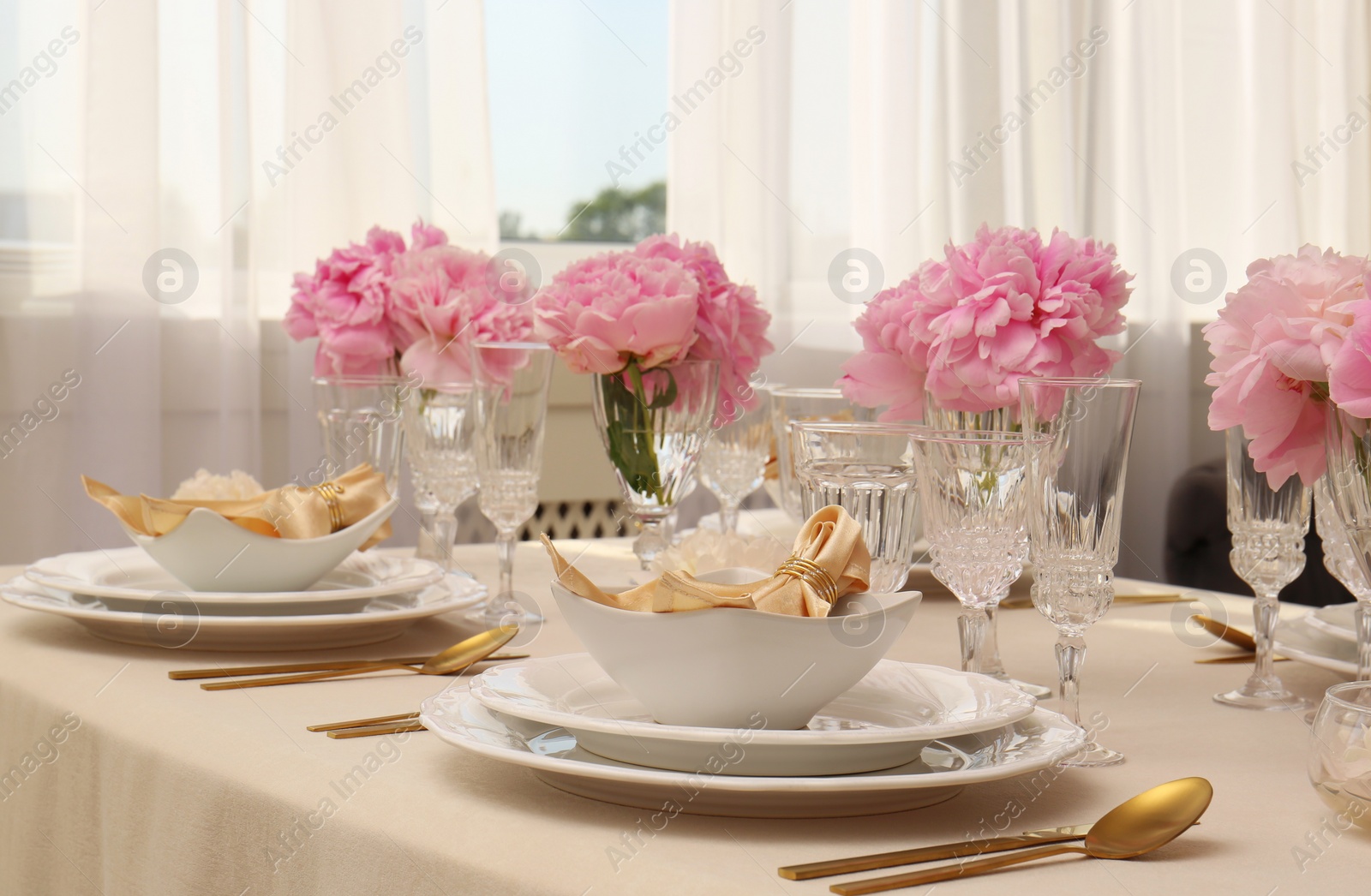 Photo of Stylish table setting with beautiful peonies and fabric napkins indoors