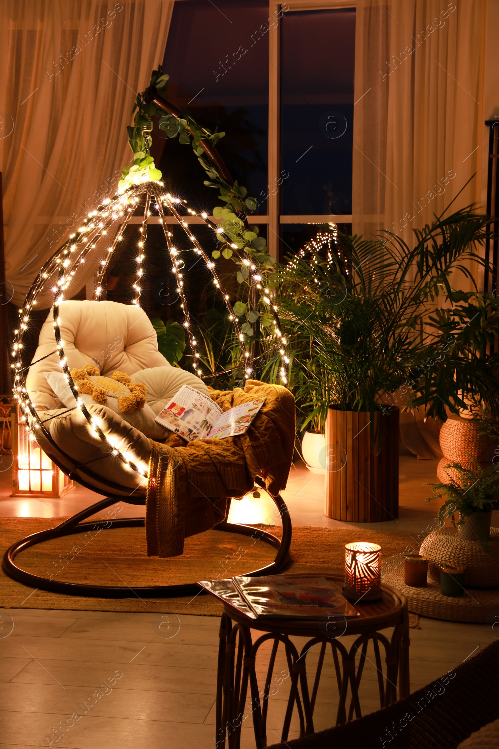 Photo of Indoor terrace interior with comfortable hanging chair and houseplants