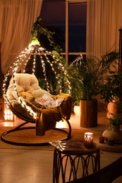 Indoor terrace interior with comfortable hanging chair and houseplants