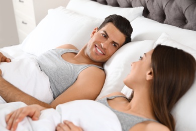 Photo of Portrait of lovely couple resting in large comfortable bed