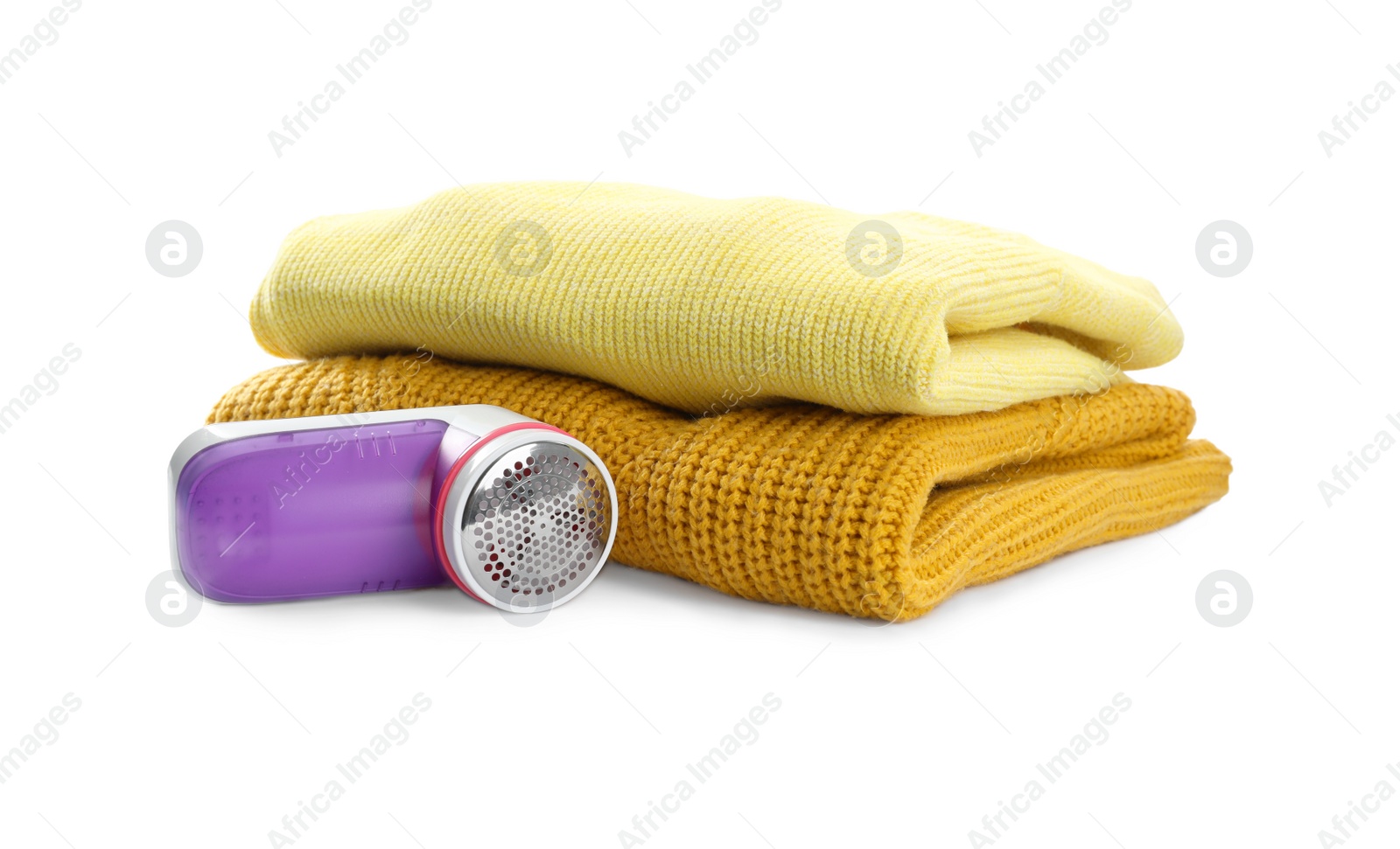 Photo of Modern fabric shaver and woolen clothes on white background