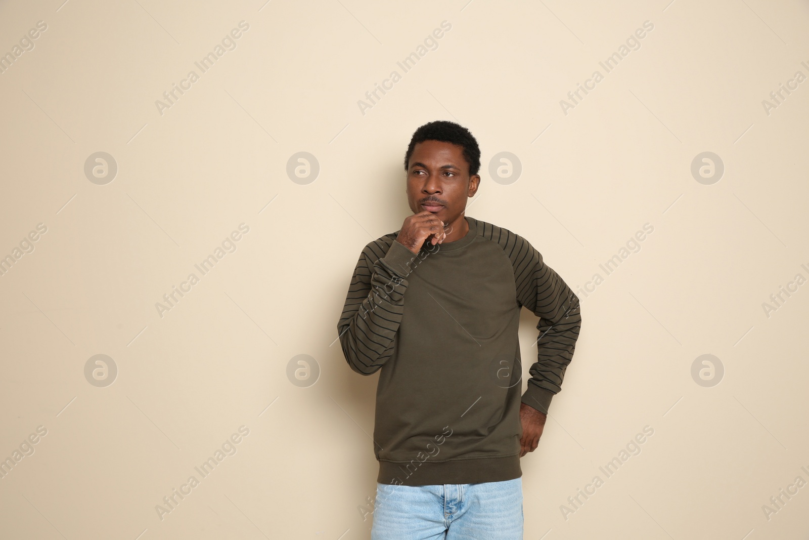 Photo of Portrait of thoughtful African-American man on color background