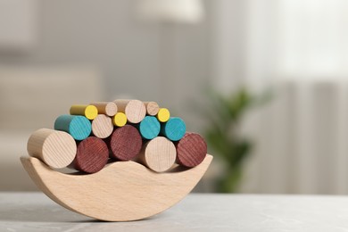 Photo of Wooden balance toy on table indoors, closeup. Space for text. Children's development