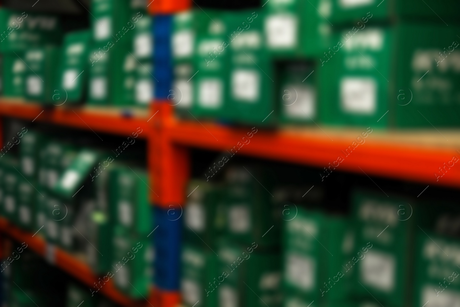 Photo of Blurred view of shelving unit with merchandise in modern wholesale shop, closeup