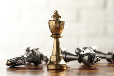 Photo of Chessboard with game pieces on light background, closeup
