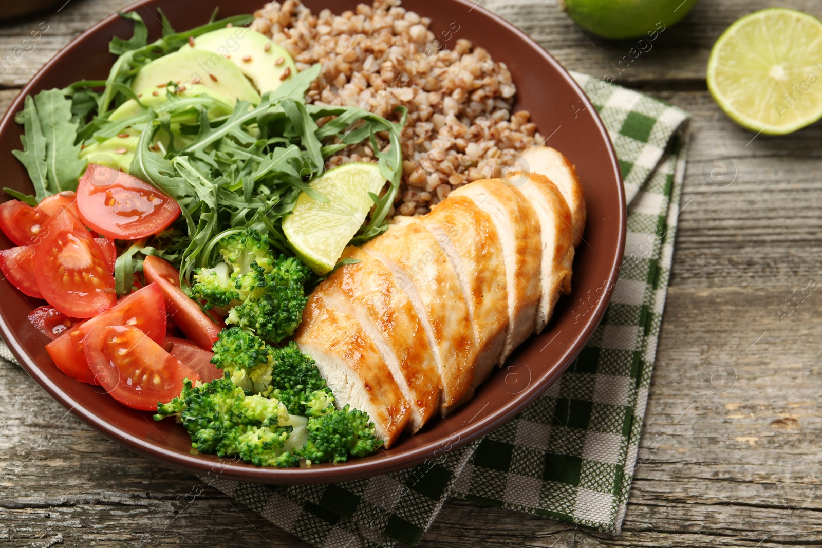 Photo of Healthy meal. Tasty products in bowl on wooden table, closeup