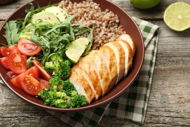 Photo of Healthy meal. Tasty products in bowl on wooden table, closeup