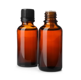 Photo of Bottles of essential oil isolated on white