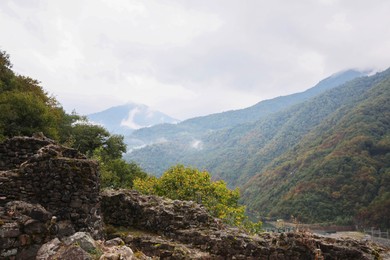 Photo of View on stone ruins and forest in mountains