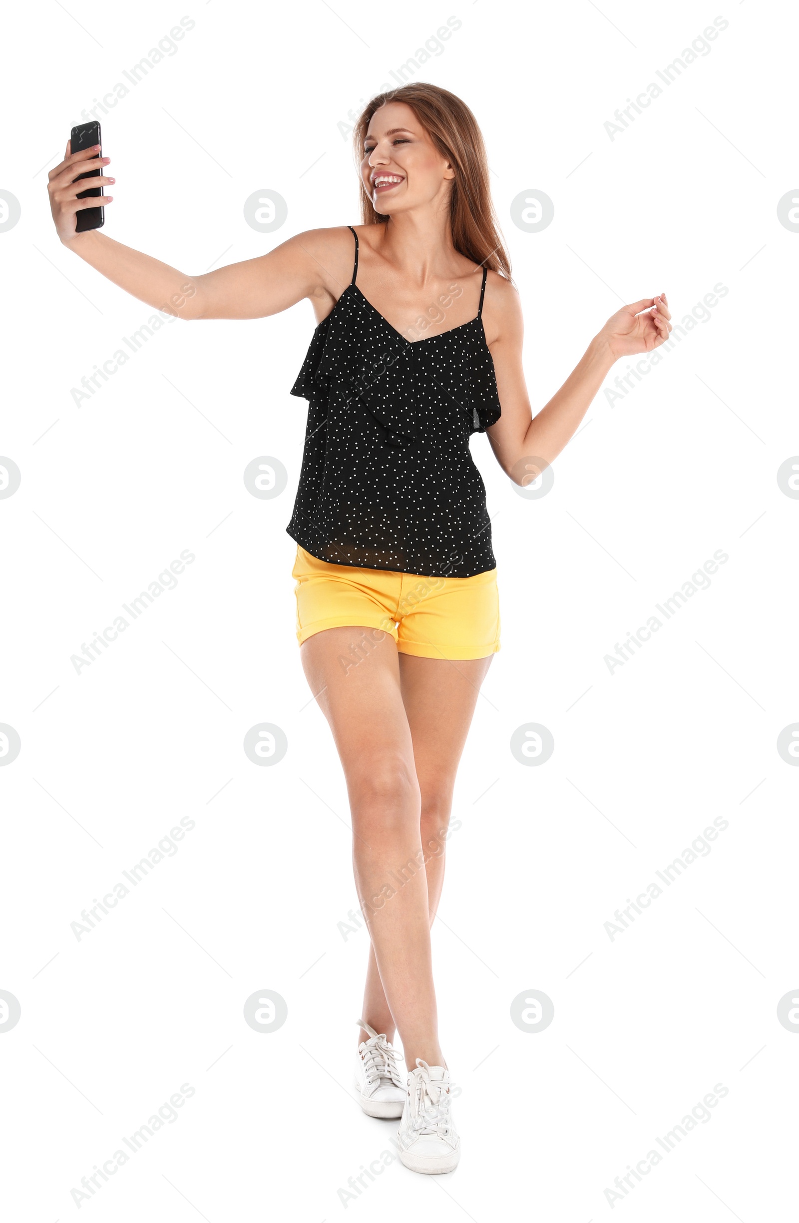 Photo of Happy young woman taking selfie on white background