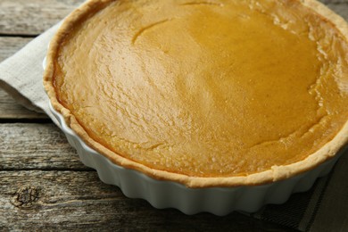 Delicious pumpkin pie on wooden table, closeup