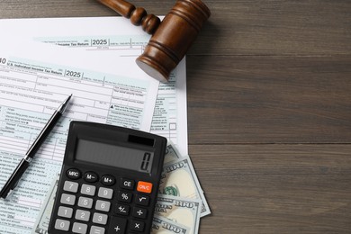 Photo of Tax law. Flat lay composition with gavel and forms on wooden table, space for text