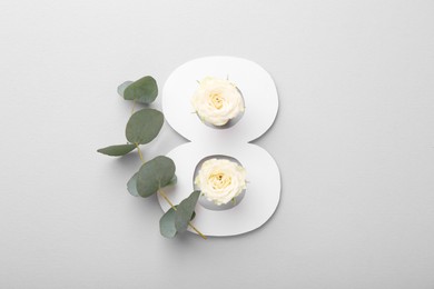 Paper number 8, beautiful flowers and eucalyptus branch on light grey background, top view