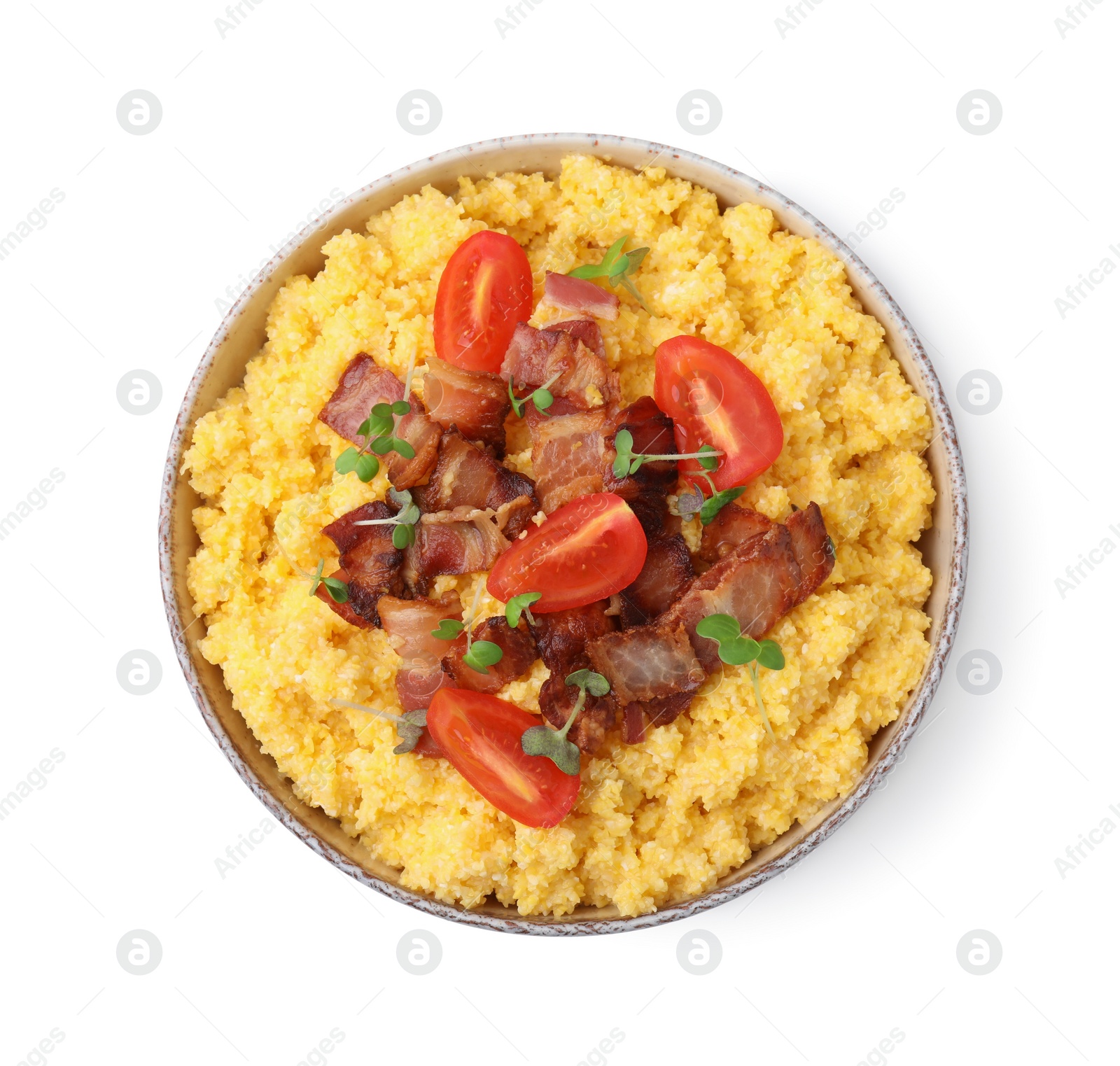 Photo of Tasty cornmeal with tomatoes, bacon and microgreens in bowl isolated on white, top view