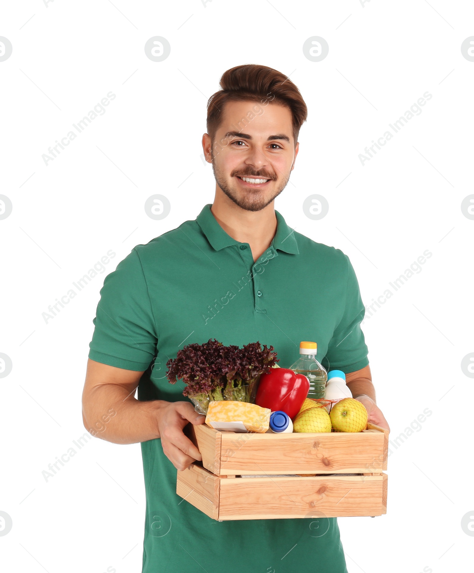 Photo of Young man holding wooden crate with products on white background. Food delivery service