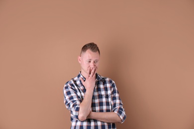 Portrait of handsome man on color background